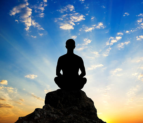 istock Silhouette of the meditating person 157705242
