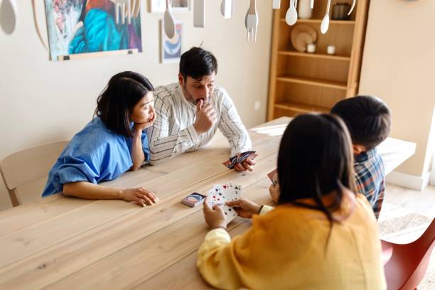 istock Family playing cards at home 1577053102