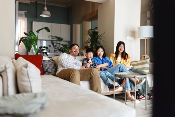 istock Family watching TV at home 1577053623