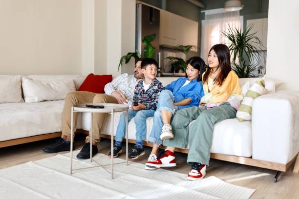 istock Multiracial family watching TV 1577054102