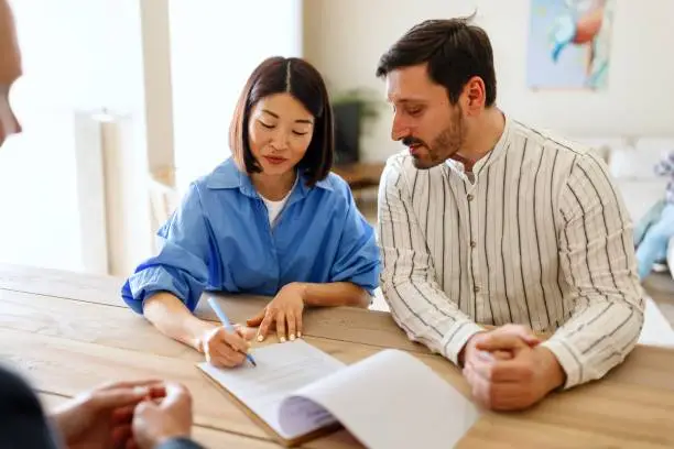 Photo of Couple signing a contract for a new apartment