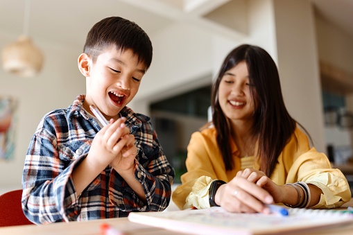 Sister and brother having fun while painting