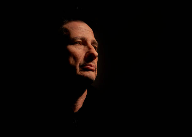 istock Mysterious man watching in the dark 1577089682