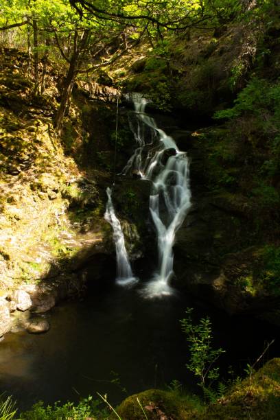 istock Stunning landscape of a mountain waterfall flowing into a deep ravine 1577092760