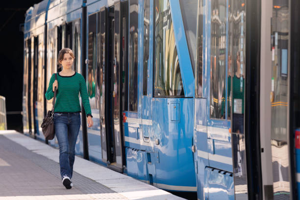 istock Girl walking on a tram station platform 1577134829