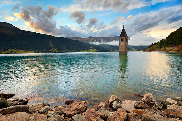 Reschensee - Lake Reschen The famous bell tower in the Lake of Reschen (Reschen See - Lago di Resia) in Südtirol, Italy. During WW2 a dam was build and put the village under water, only the tower is still visible now. A legend says that during winter one can still hear church bells ring... alto adige italy photos stock pictures, royalty-free photos & images