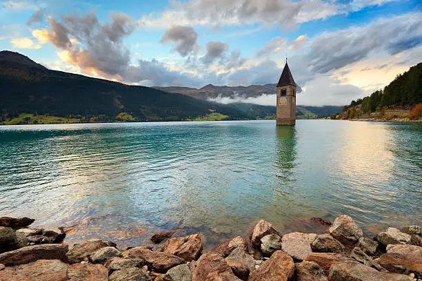 The famous bell tower in the Lake of Reschen (Reschen See - Lago di Resia) in Südtirol, Italy. During WW2 a dam was build and put the village under water, only the tower is still visible now. A legend says that during winter one can still hear church bells ring...