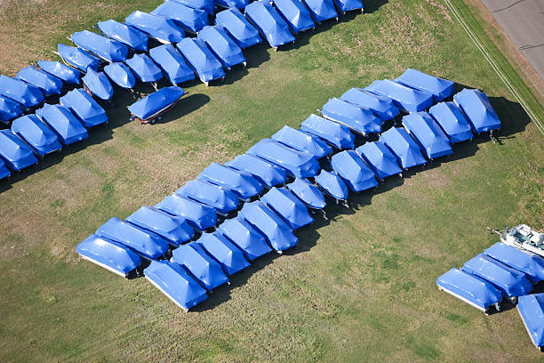 Boats Shrink Wrapped and Winterized for Storage An aerial view of small fishing and pontoon boats shrink wrapped and winterized for off-season storage. Shrink wrapping allows the boats to be stored outside, eliminating the need for a building.
http://www.banksphotos.com/LightboxBanners/Aerial.jpg mini pontoon boats stock pictures, royalty-free photos & images