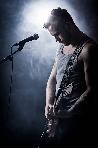 istock Rocker playing the guitar with smoke in the background 157718101