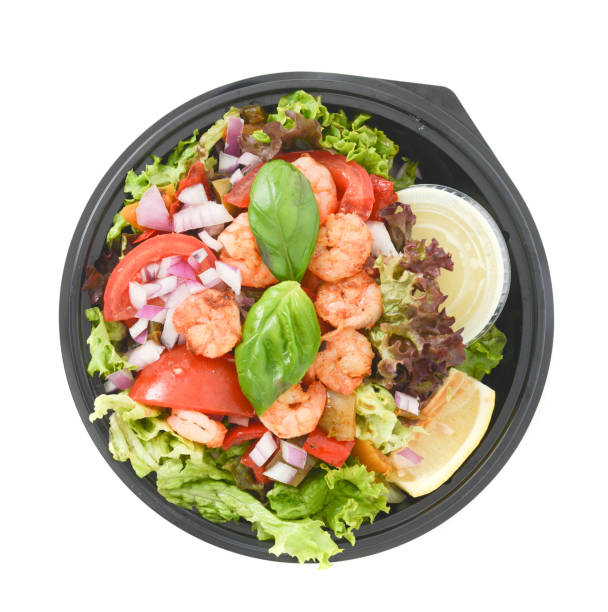 A close-up of salad with grilled prawns and cherry tomatoes