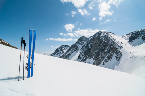 Free-skier riding on a big mountain terrain with fresh powder snow cover