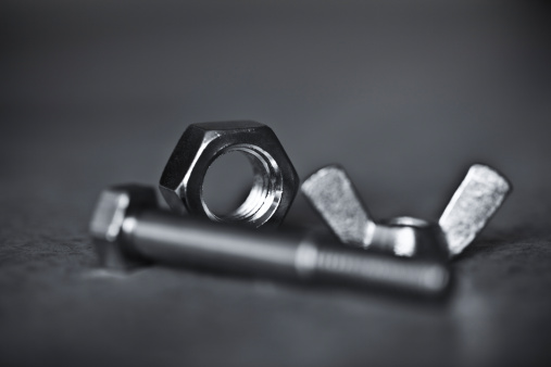 close-up of steel nuts and bolts. shallow depth of field.