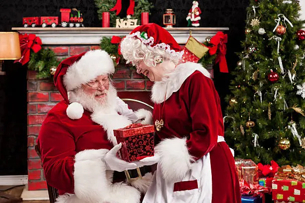 Real Santa and Mrs. Claus Giving Gifts to Each Other