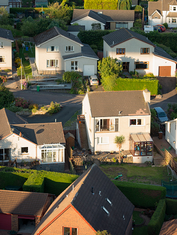 Detached British houses, photographed in evening sunshine from above.