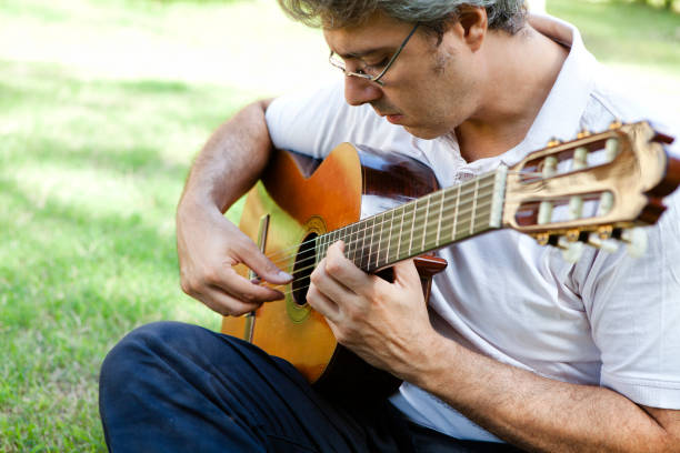 istock Man Playing Classic Guitar Outdoors 157718681