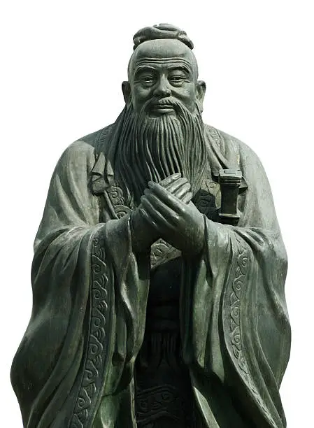 Photo of Gray statue of Confucious holding his hands together
