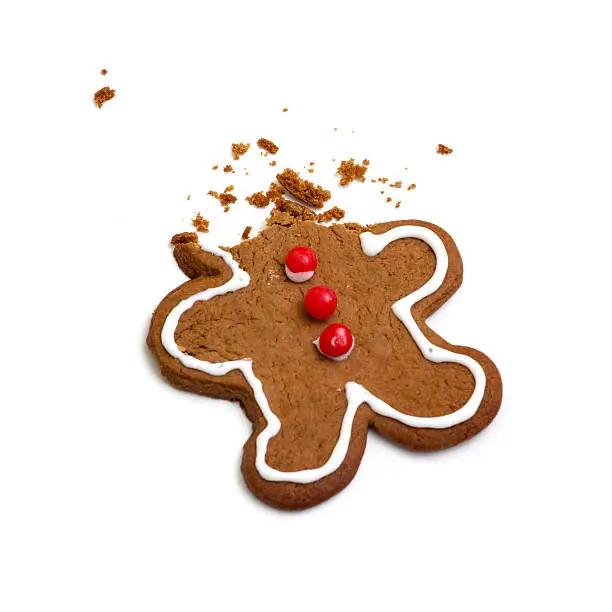 A gingerbread man's head has been eaten with only crumbs left (on white background.)