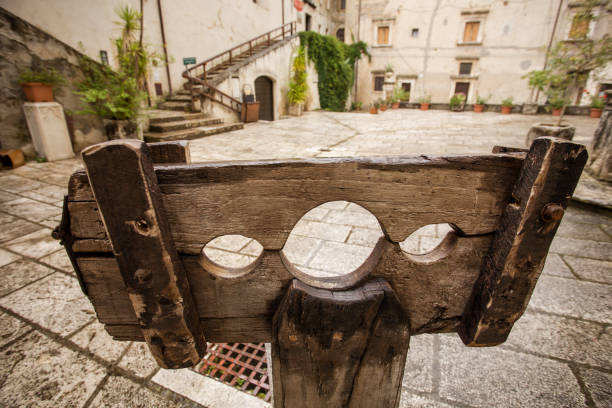Medieval Pillory in a Village Square A medieval pillory, antique device used for punishment settled in the main square of a village medieval restraints stock pictures, royalty-free photos & images