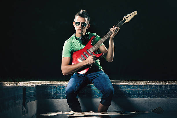 istock young guy electric guitar by the pool 157720086