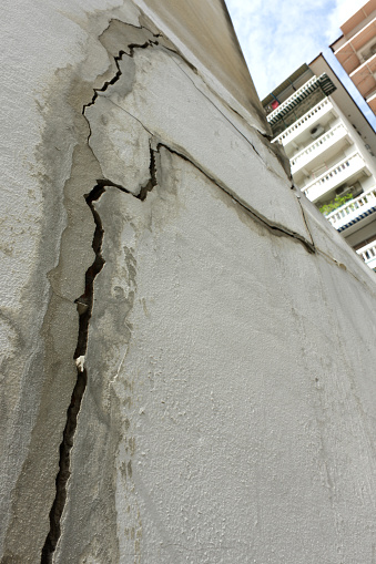 Severe cracks in a concrete residential building, caused by subsidence. Southeast Asia.
