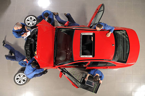Auto mechanic team repairing the sports car stock photo