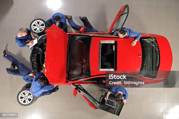 Auto Mechanic Team Repairing The Sports Car Stock Photo - Download Image Now - Car, Repairing, Auto Repair Shop