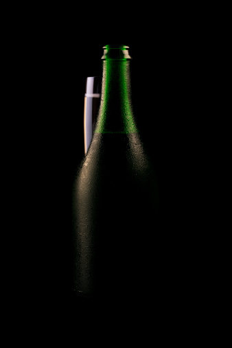 Alcoholic background, champagne without label on an atmospheric wooden background. Side view.