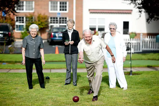 Seniors at a retirement center having fun outside.