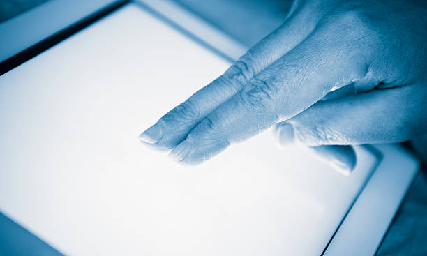 istock fingers touching the screen of a digital tablet 157724545