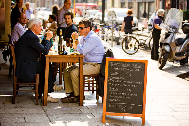 Dublin, Republic of Ireland - July 14, 2011: People eating outside the Oliver St. John Gogarty public house/restaurant in the Temple Bar district of Dublin. There is a sculpture to Gogarty and his friend the author, James Joyce. Oliver Joseph St John Gogarty (1878-1957) was a poet, surgeon, athlete and politician. James Joyce, modelled his character Buck Mulligan (in the novel Ulysses) on him.
