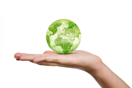 A young woman's holding a green globe.