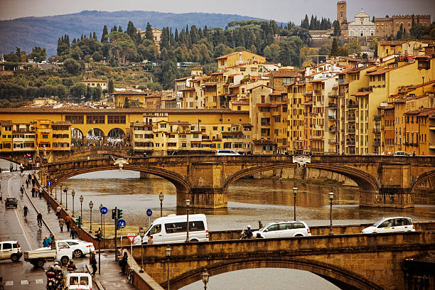 Florence, Tuscany, Italy - 04 01 2024: The Ponte Santa Trinita and the Ponte Vecchio are historic bridges that connect the two sides of the historic centre, crossing the Arno River.