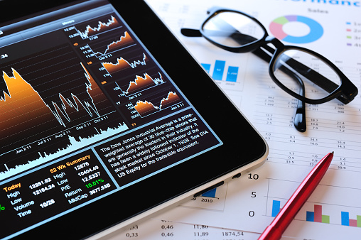 Cropped image of professional broker show tablet displayed growth graph in skilled trader at stock market. Stock investment. Stock trading. Stock market trading concept. Burgeoning.