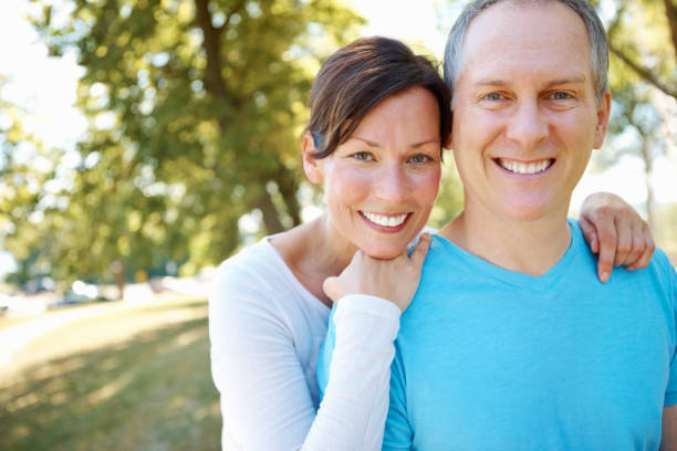 istock Smiling couple with woman leaning on man's shoulder 157725167