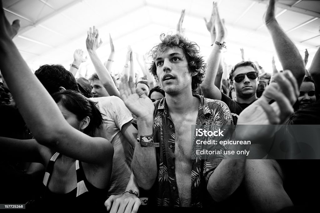 Young man clapping as he watches a performance  Black And White Stock Photo