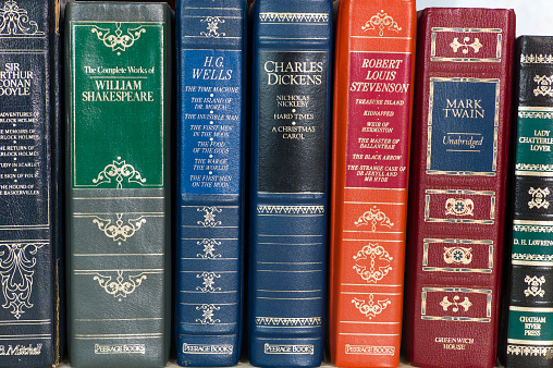 Mahone Bay, Canada - November 10, 2011: A row of leather bound books from several classic authors and various publishers.  These books were published in the 1980s and were popular to collect at that time.