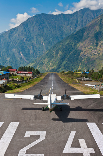 Front view of plane at airport. Commercial airplane taxiing from runway to gate.