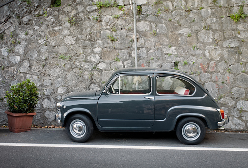 Siracusa, Ortigia, Italy: vintage, red Fiat 500 shown parked on a street in historic Ortigia, Sicily. The cinquecento is a city car produced by the Italian manufacturer Fiat between 1957 and 1975.