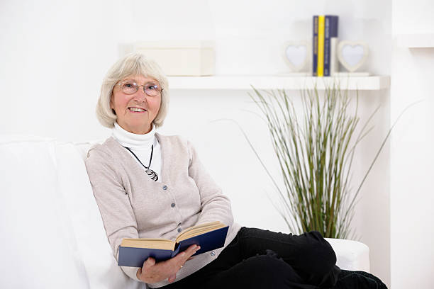 istock Caucasian Senior Woman With Spectacles Reading A Book 157726467