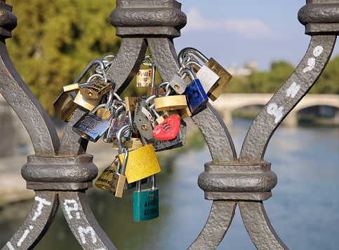 Many locks for happiness, love and luck. Ritual and superstition. Tourist travel embankment. Street background.