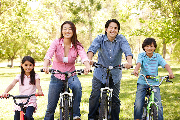 istock Asian family riding bikes in park 157727012