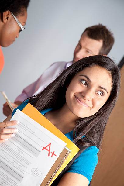 istock Smiling Latin college student receives A+ grade on Calculus Test. 157727256