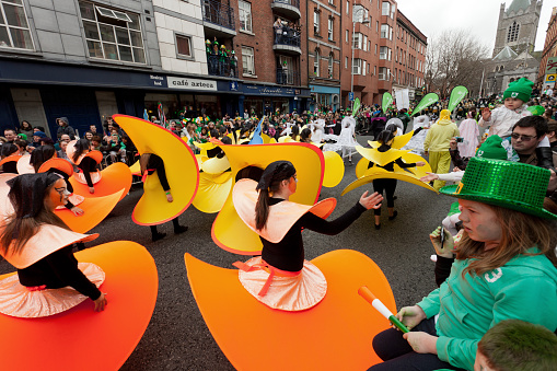 Dublin, Ireland - March 17, 2011:Children in their colorful costumes, participating  Dublin St Patrick's day parade with spectators in mostly Irish colors.