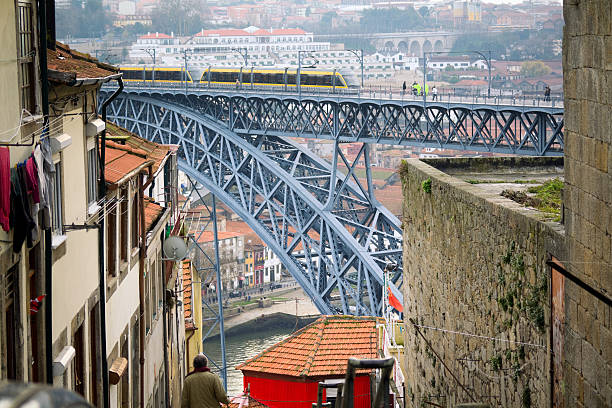 A close-up of the intricate steelwork making up the arch of the Maria Pia Bridge over the Douro River in Porto, Portugal.