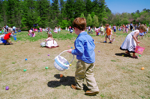 Belmont, North Carolina, USA - April 4, 2010: Children scramble to collect eggs during an Easter Egg Hunt on Easter Sunday at Belmont Abbey College.