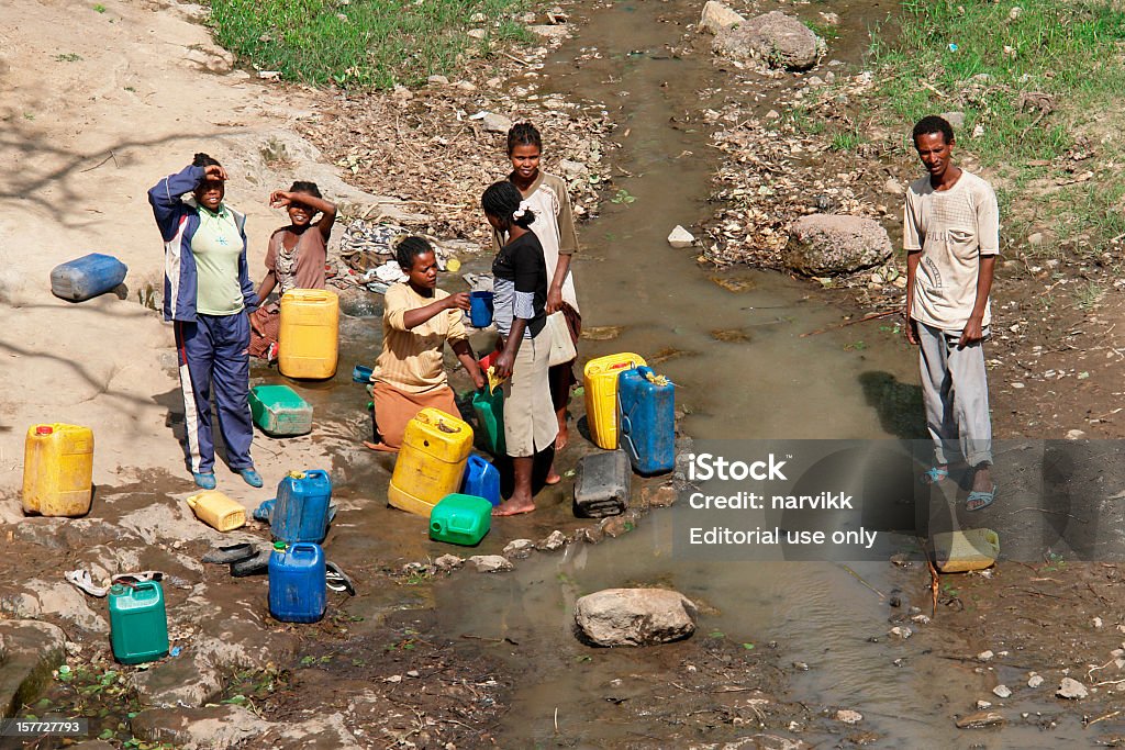 Local ethiopians taking water to plastic canisters  Drought Stock Photo