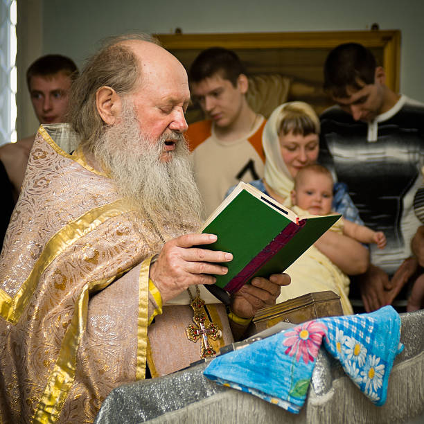 The priest holds the wedding rings on a saucer near the bible. Orthodox father bless wedding rings for newlyweds. Retro old style