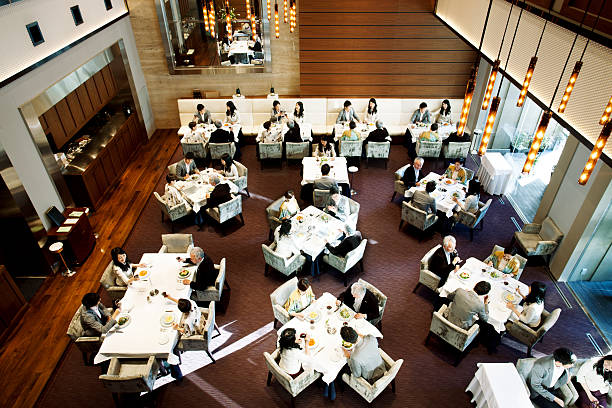 Busy Japanese Restaurant Japanese restaurant, Tokyo. Note: the same four people at each table. busy restaurant tables stock pictures, royalty-free photos & images