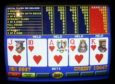 New Orleans, Louisiana, USA - December 16, 2004:  Image of a IGT Deuces Wild .25 Progressive Video Poker Machine. Drawing one card to the Royal Flush of Hearts for a Jackpot total of $2,491.62.