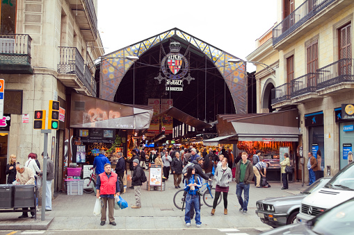 People visit local market hall Mercat de Sant Antoni in Barcelona, Spain.